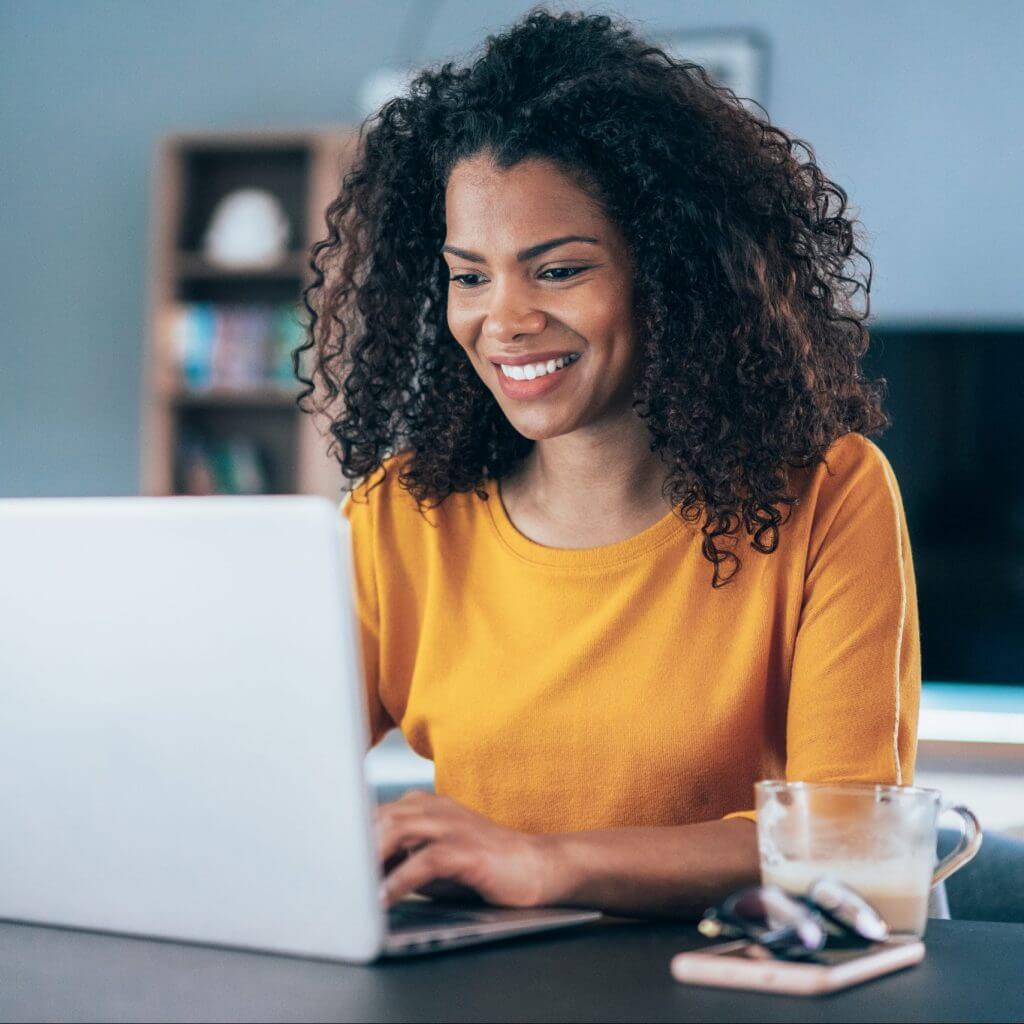 Woman setting up an automated text message using her computer