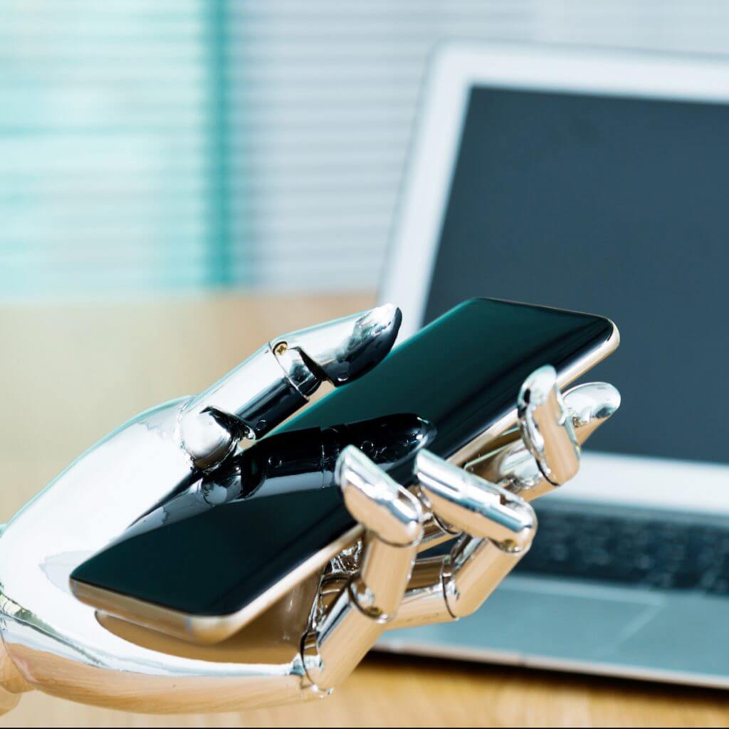Robot hand holding a phone to indicate an SMS auto reply