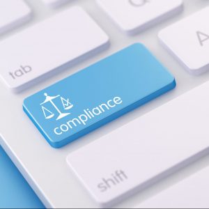 Close-up of keyboard with a Compliance button, illustrating Soc 2 compliance