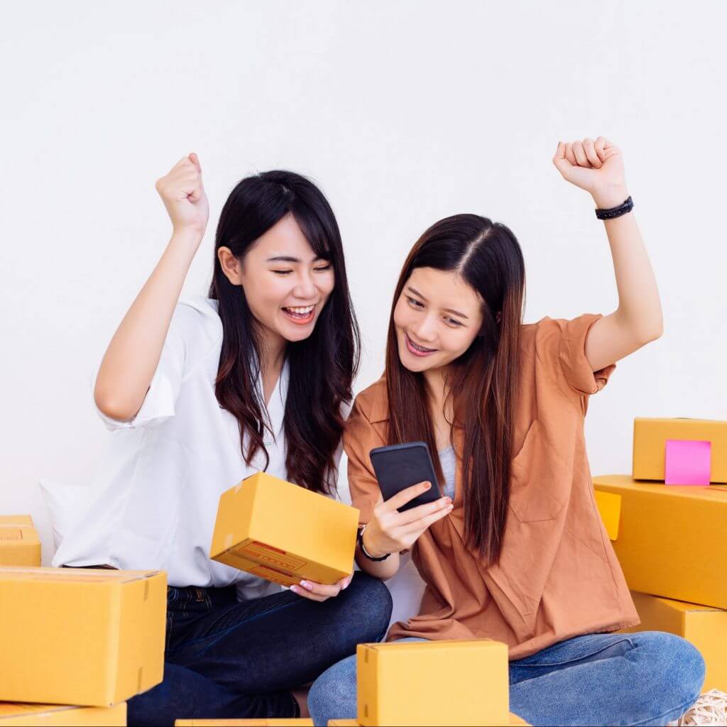 Two women in an office using business texting services for small business