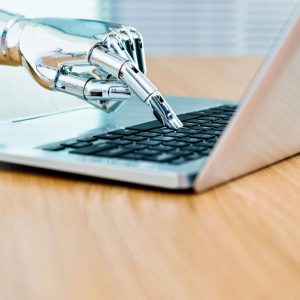 Robot hand on keyboard to signify omnichannel chatbot