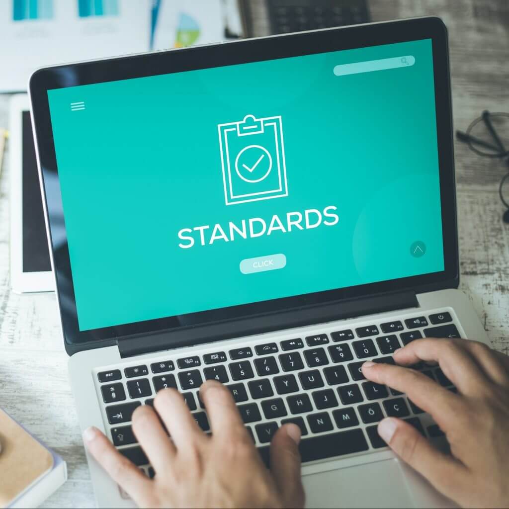Laptop screen with the word "standards," signifying sms compliance checklist