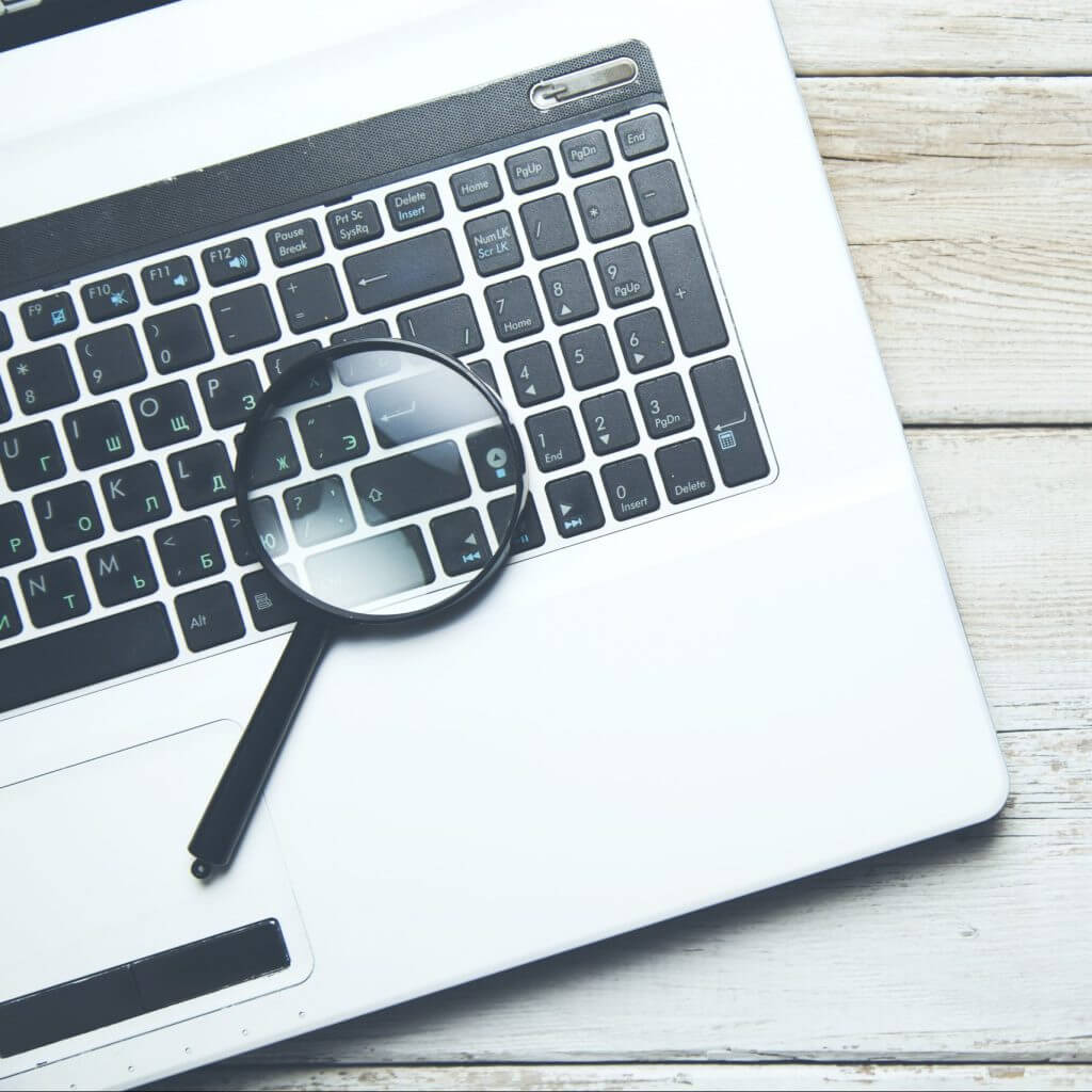 Computer with magnifying glass to show searching for a secure text messaging platform