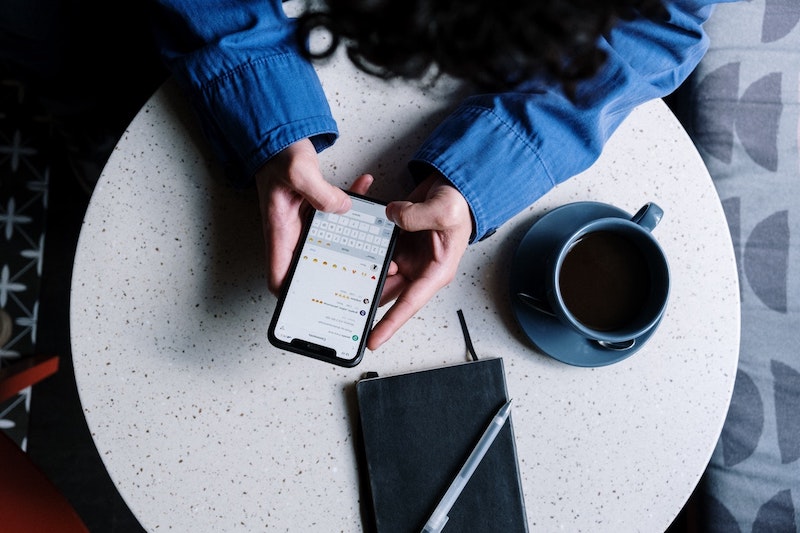 Hands holding phone using Instagram Business Messaging