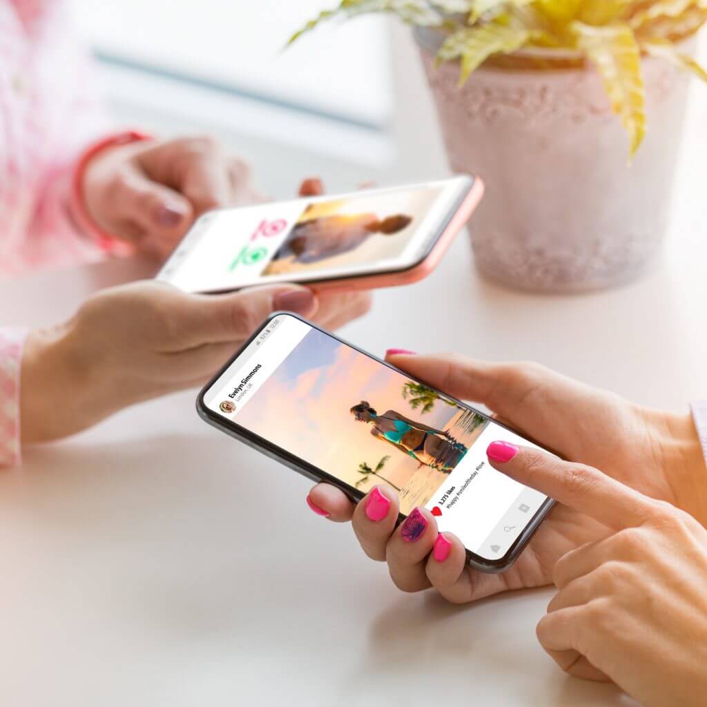 Two women's hands shown browsing Instagram, where companies can now use sms templates