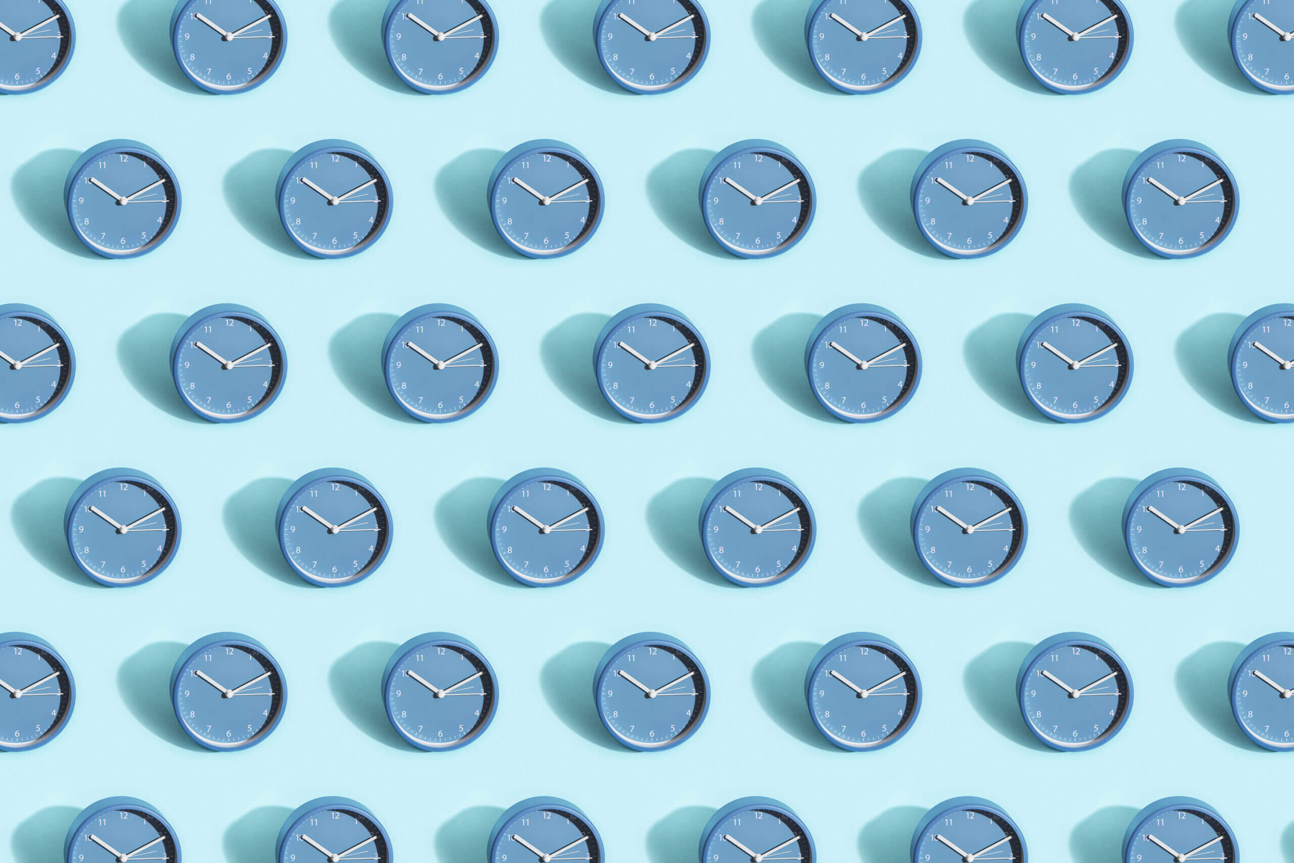 Clocks against a blue background to show popular business texting times