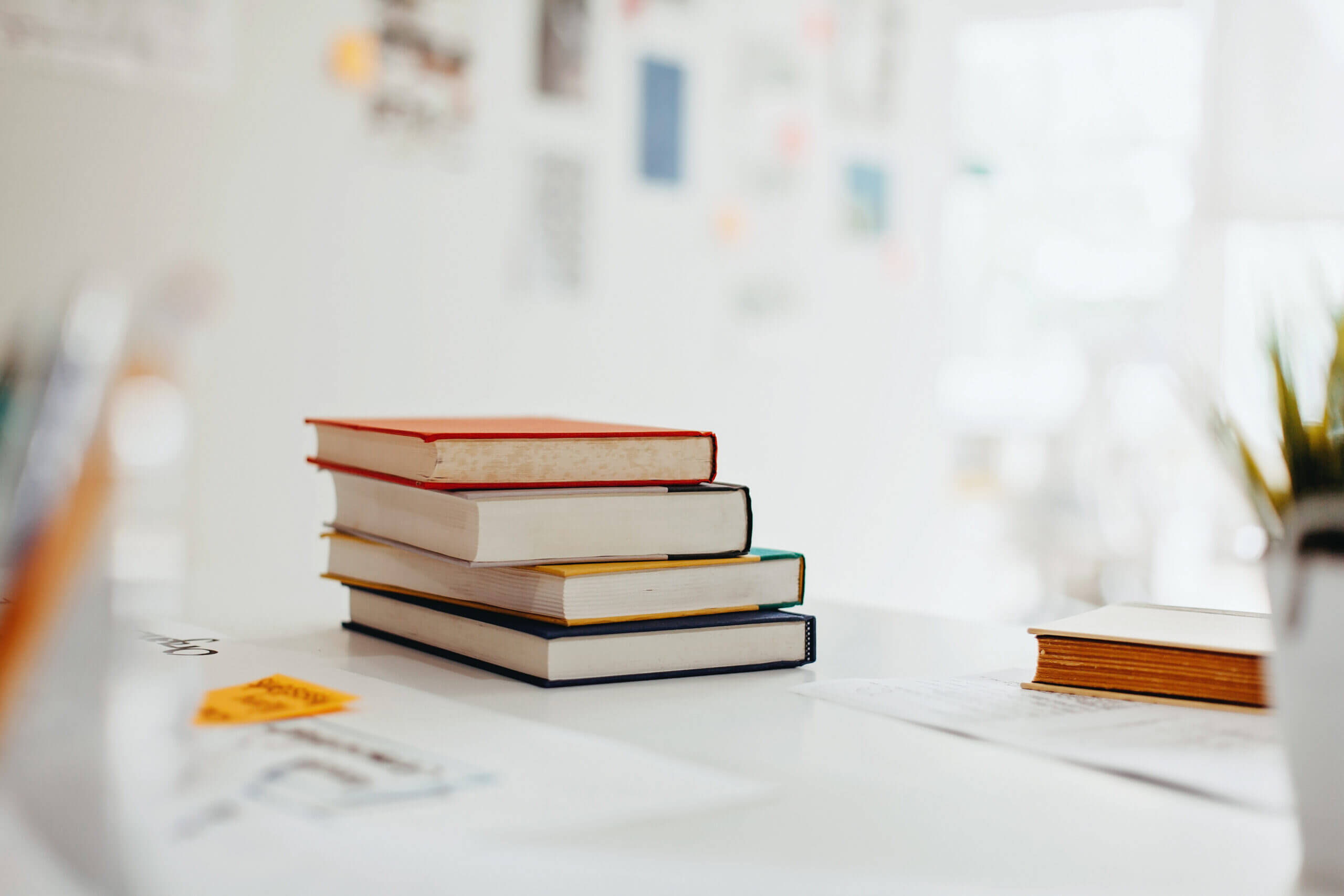 Image of pile of books to learn more about SMS eCommerce Resources