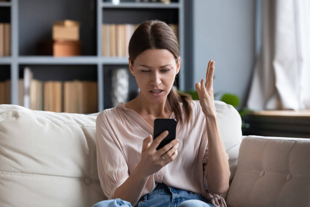 Woman recieving a text message promotion she considers spam