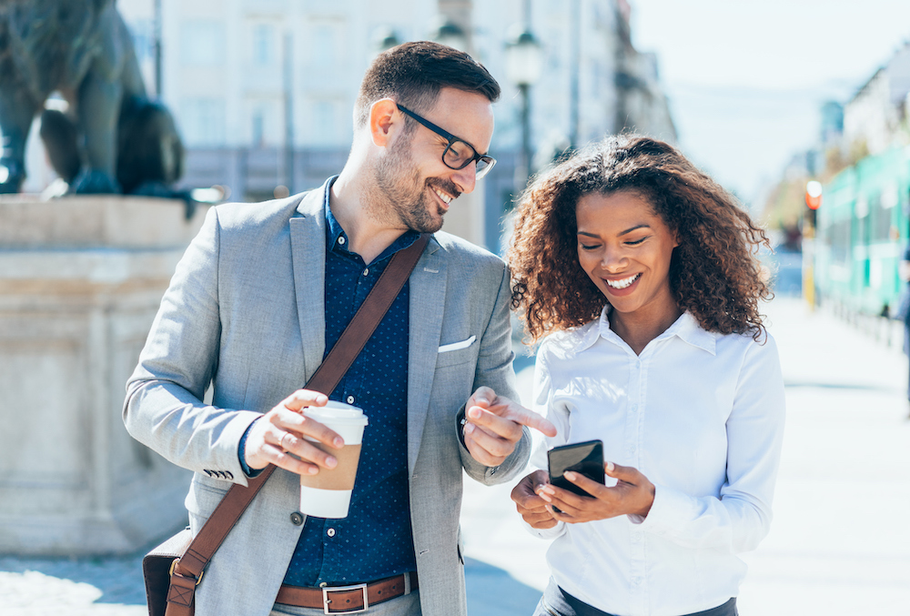 Two colleagues collaborating on a text using conversational customer engagement