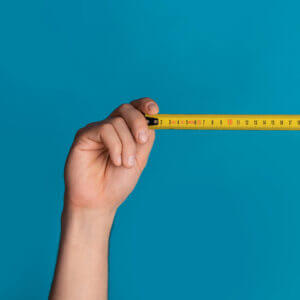 Hands holding tape measure to demonstrate conversational marketing KPI