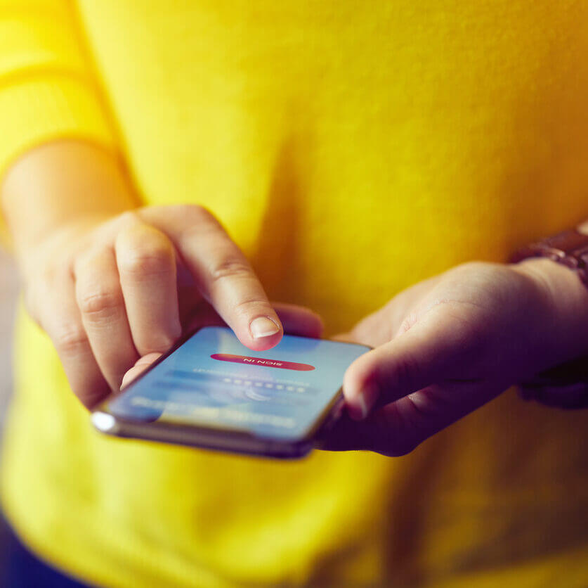 Woman texting using a 10 digit phone number, also known as a 10DLC