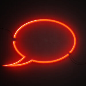 Glowing speech bubble against dark background
