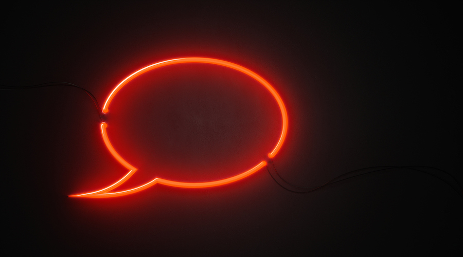 Glowing speech bubble against dark background
