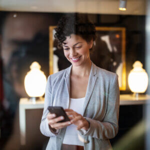 Businesswoman sending a text using a texting service for business