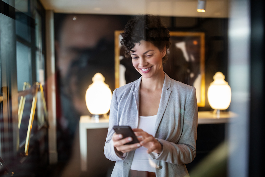 Businesswoman sending a text using a texting service for business