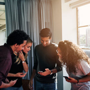 Group of young professionals looking at cellphones