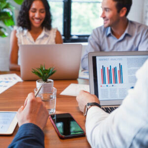 A group of businesspeople with laptops and cellphones