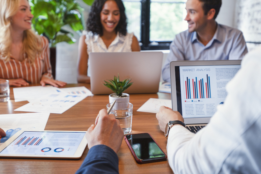 A group of businesspeople with laptops and cellphones
