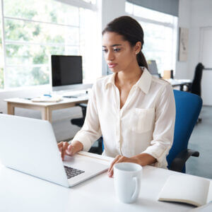 A businesswoman typing on her computer.