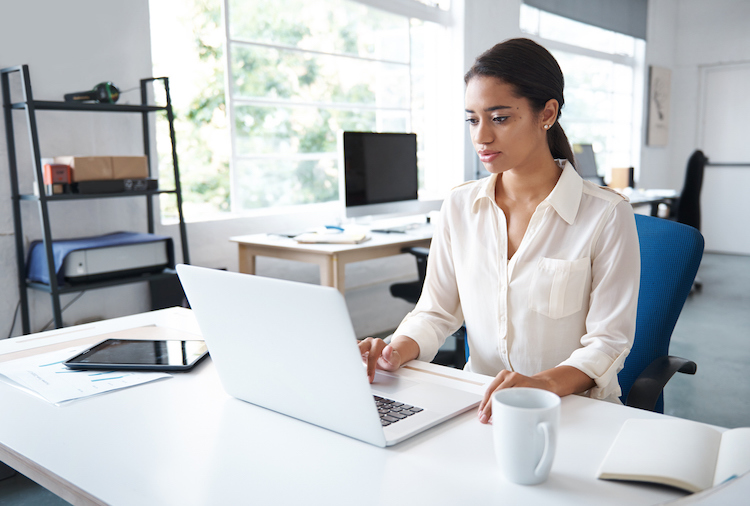 A businesswoman typing on her computer.