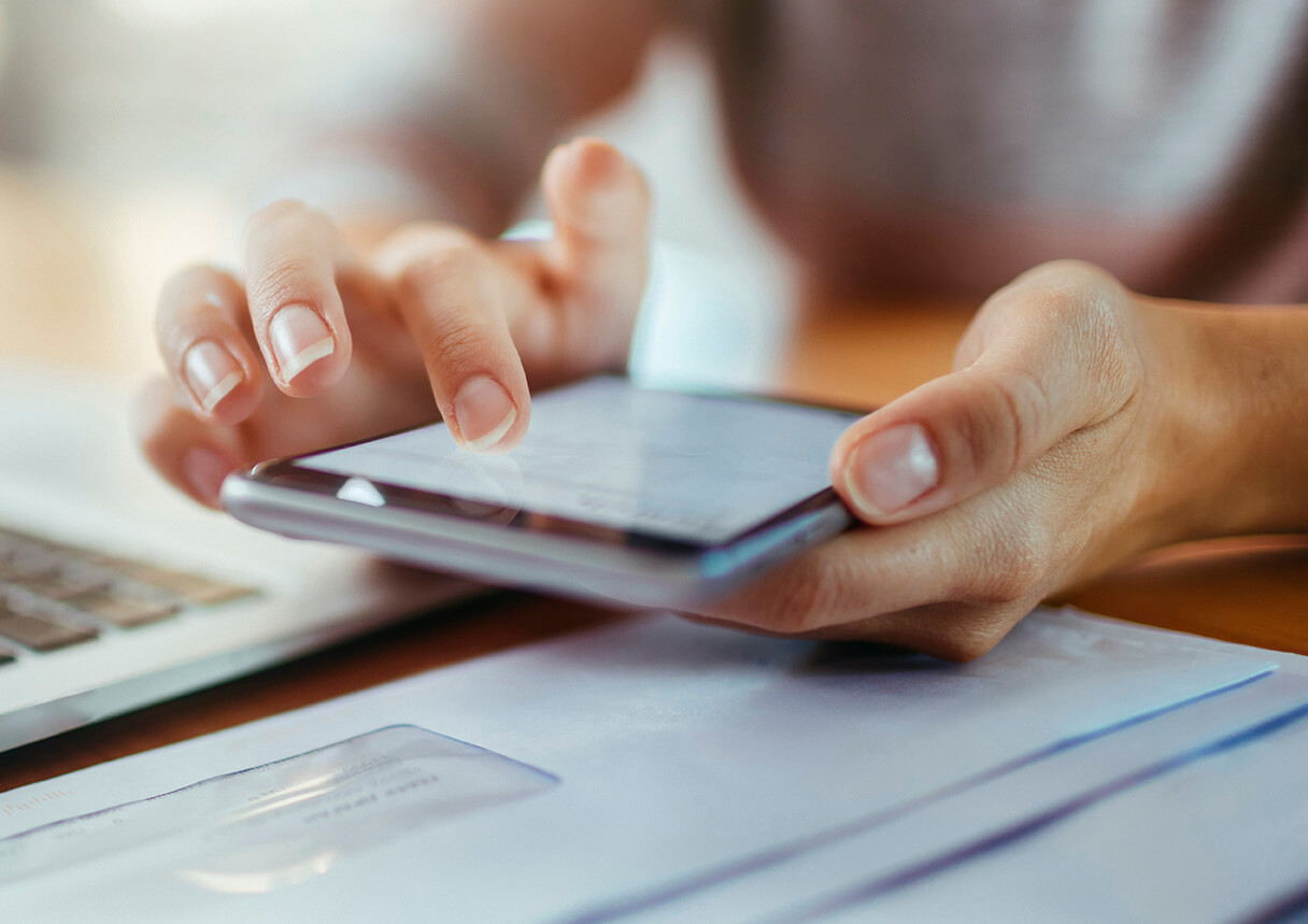 Firm team member scrolling through client messages on phone