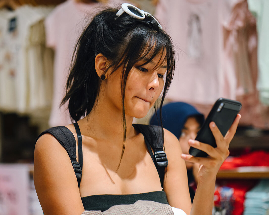 Shopper looking at SMS marketing content on her phone