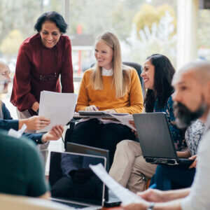 Group of professionals gathered around their computers.