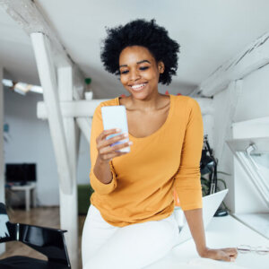 Woman shopping on her smartphone using conversational commerce