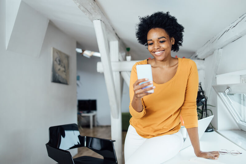 Woman shopping on her smartphone using conversational commerce