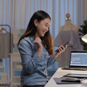 eCommerce store owner smiling and looking at her phone