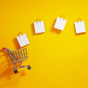 Shopping cart with shopping bags coming out of it