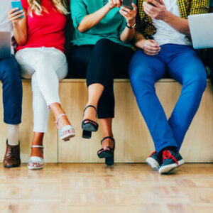 Group of students sitting with their mobile phones and computers