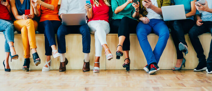 Group of students sitting with their mobile phones and computers