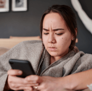 Woman receiving a fake text message