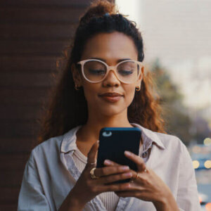 Woman typing into mobile phone.