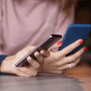 Hands texting on Android phone.