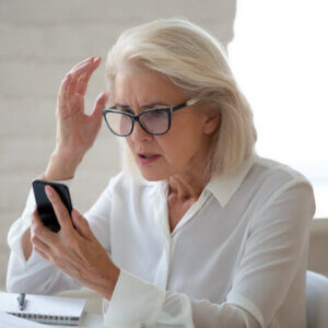 Frustrated woman reporting a spam text