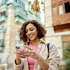 Woman sending a text from an iPhone.