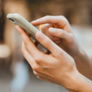 Hand holding phone and texting